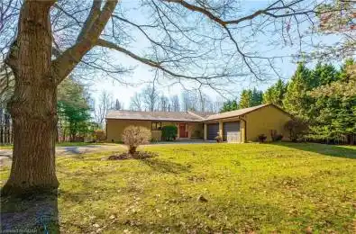 View of front of property featuring a garage and a front yard