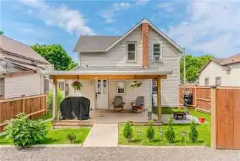 Back of house with an outdoor fire pit